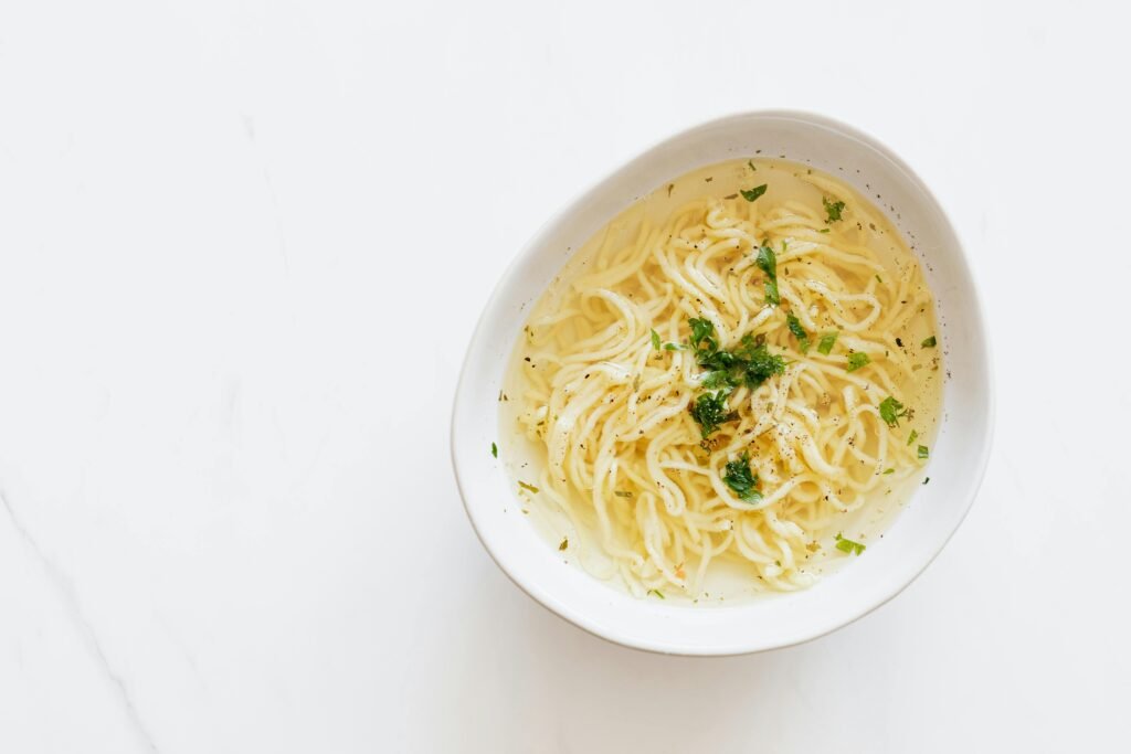 Bowl of coconut chicken soup with lime and cilantro