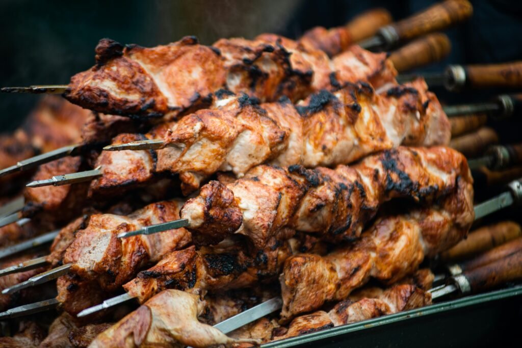 Grilled Thai pork skewers sizzling with golden edges.