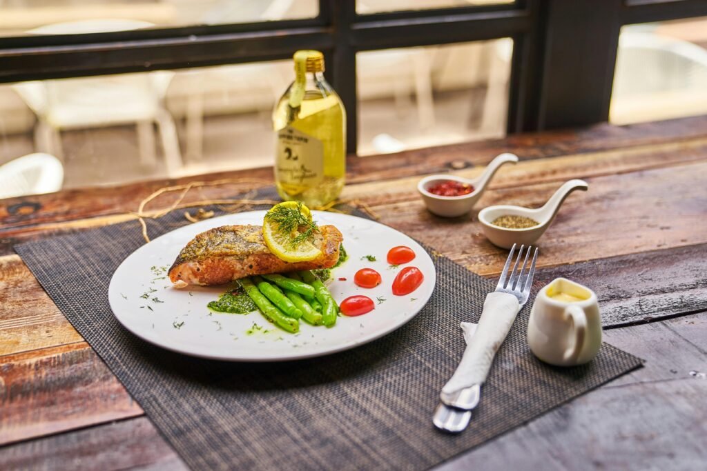 Baked salmon with lemon wedges and fresh herbs