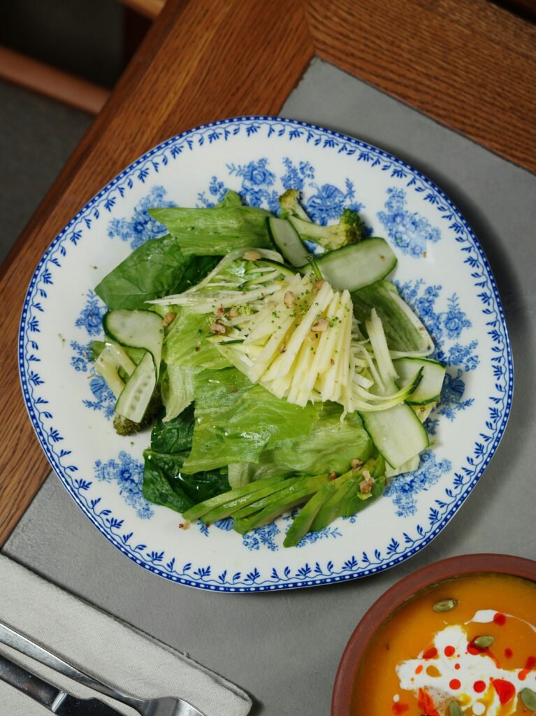 Refreshing Thai cucumber relish with sliced red chili in a white bowl.