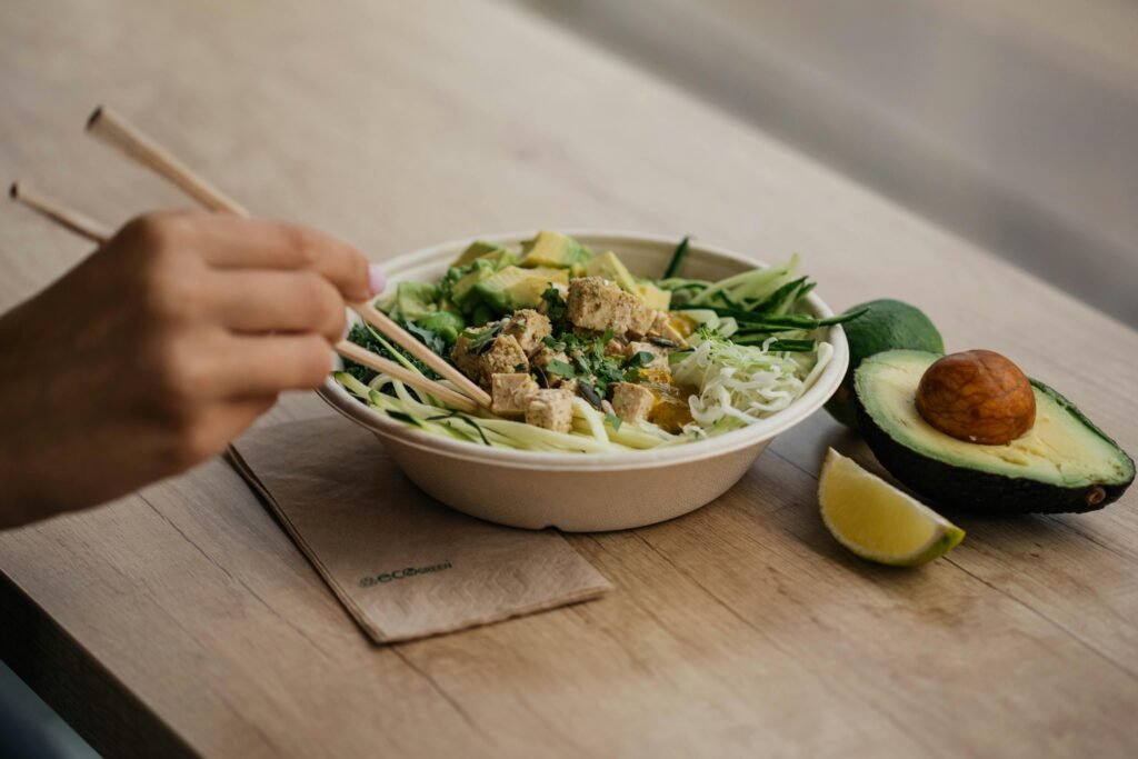 Zoodle pasta with pesto and tomatoes in a bowl